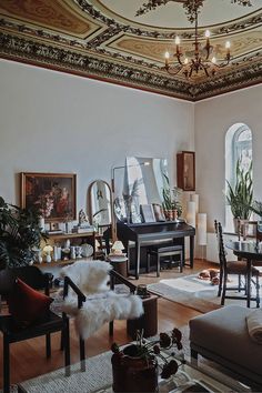 a living room filled with lots of furniture and decor on top of a hard wood floor