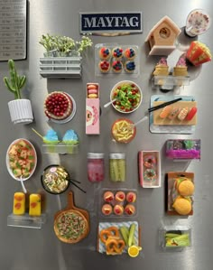 a refrigerator covered in lots of different types of food and condiments on top of it