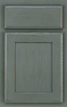 an image of a kitchen cabinet door painted in blue and grey colors with white trim