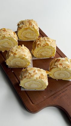 several pieces of cake sitting on top of a cutting board