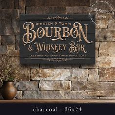 a wooden sign that says bourbon and whiskey bar on the side of a stone wall