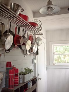 pots and pans are hanging on the wall