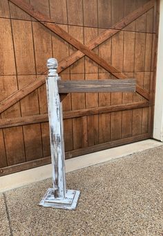 an old fashioned wooden post stands in front of a barn door with wood slats