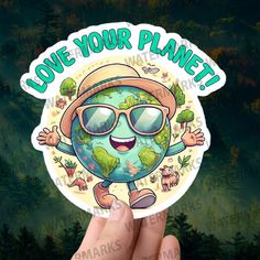 someone holding up a sticker that says love your planet with the earth wearing sunglasses