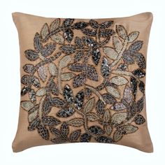 a decorative pillow with sequins and leaves on the front, in beige color