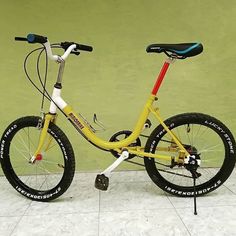 a yellow bicycle with black and white tires