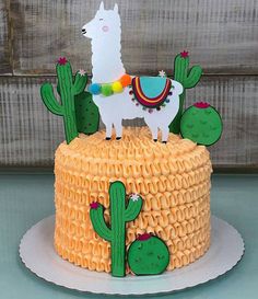 a cake decorated with an image of a llama and cactus