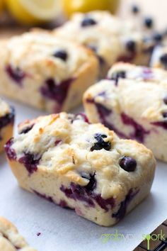 blueberry muffins on a baking sheet with lemons in the background