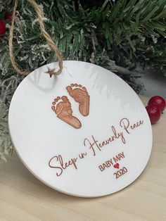 a ceramic ornament with a baby's footprints on it