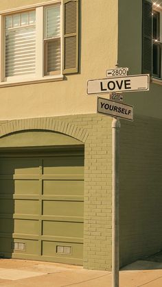 a couple of street signs sitting on the side of a road next to a building