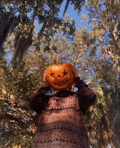 a scarecrow with a pumpkin on his head