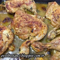 some chicken is cooking in a pan with broth and spices on the bottom half