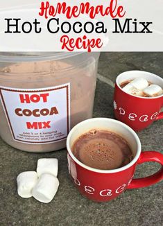 homemade hot cocoa mix in a red mug with marshmallows next to it