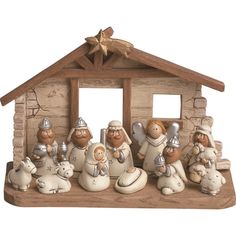 a group of figurines sitting in front of a nativity scene