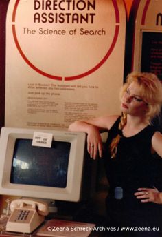 a woman standing in front of an old computer with the words direction assistant on it