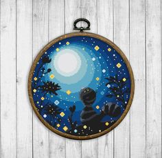 a cross stitch pattern in the shape of a round frame with an image of a raccoon at night