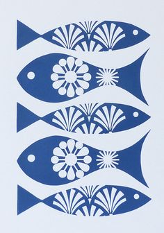 four blue and white fish with flowers in the middle, on a white paper background