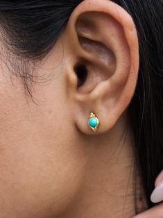 A R I Z O N A ∙ T U R Q U O I S E ∙ S T U D S These studs are crafted with 24k gold vermeil over 925 sterling silver. Each earring features a stunning round cabochon turquoise gemstone, elegantly set within a charming shell design with dots accenting the piece and enhanceing its natural beauty. The vibrant blue-green hues of the turquoise create a captivating contrast against the warm gold, making these earrings a perfect accessory for any occasion. Lightweight and comfortable. This earring is also available in other gemstones. Please write to us for customisations.  * Material: 24K Gold Vermeil on 925 Sterling Silver - Hypo-Allergenic and Nickel Free * Finish: 24K Gold Vermeil on 925 Sterling Silver | Also available in solid 925 Sterling Silver * Featuring a 4 MM Round natural Arizona Tur Handcrafted Silver Jewelry, Turquoise Stud Earrings, Shell Design, Arizona Turquoise, Green Hues, Natural Stone Jewelry, Handmade Jewelry Gift, Wedding Jewelry Earrings, Vibrant Blue