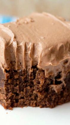 a close up of a piece of cake on a plate with frosted icing