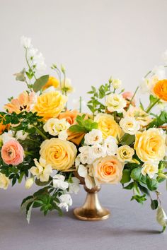 a vase filled with yellow and white flowers