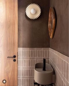 a bathroom with brown walls and white tile