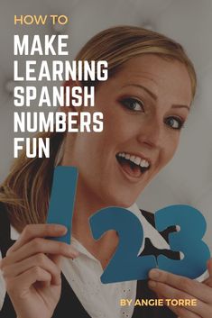 a woman holding up the numbers to make learning spanish numbers fun