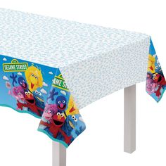 the sesame street tablecloth is blue and has cartoon characters on it