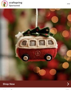 a red ornament hanging from a christmas tree