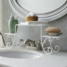 a bathroom sink with soap, shampoo and toothbrushes on the shelf next to it