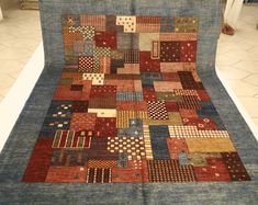 an old patchwork rug is displayed on the floor