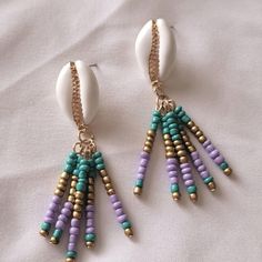 Beach Vacation Vibes Seashell Beaded Earrings Turquoise Purple With Gold Details New Beach Jewelry With Colorful Purple Beads, Purple Jewelry With Colorful Beads For Beach, Purple Dangle Jewelry For Beach, Colorful Beaded Dangle Earrings For Beach, Purple Dangle Earrings For Beach, Purple Dangle Earrings For The Beach, Bohemian Purple Beaded Earrings For Beach, Purple Bohemian Earrings For Beach, Colorful Beaded Earrings For The Beach