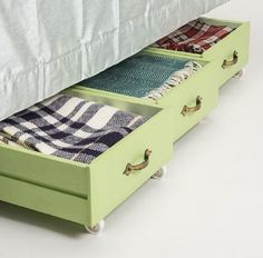 two drawers are open on the bottom of a bed