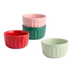 three different colored bowls sitting next to each other