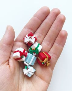 small christmas presents are placed in the palm of someone's hand