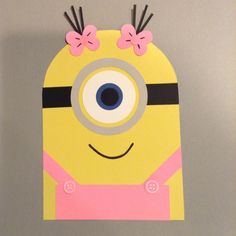 a paper cut out of a yellow and pink minion