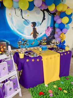 a birthday party with balloons and decorations on the wall, including purple table cloths