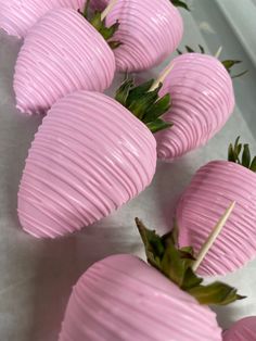 some pink strawberries are sitting on the table