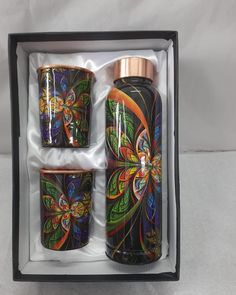 two colorful cups in a black box on a white surface