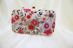 beige silk wedding clutch bride purse minaudiere with colorful flowers | beautiful zardosi sequin thread embroidery woman clutch for eveningTake your look to the bold attitude with this embellished clutch. Defined by beautiful Zardosi. Make it the ideal addition to any stand-out style.Height : 4.5inchWidth : 8inchDepth : 2inchHandmade Clutch.Suitable for every special occasion.Add grace to your dressings.Perfect For Weddings, Parties Etc.These bags can be also used for gift purpose .We welcome w Embroidered Clutch For Wedding Guest, Multicolor Clutch With Floral Embroidery For Festive Occasions, Festive Multicolor Clutch For Reception, Multicolor Floral Embroidered Clutch For Festive Occasions, Gold Clutch With Resham Embroidery For Parties, Gold Clutch With Resham Embroidery For Evening, Multicolor Embroidered Clutch For Wedding, Multicolor Handwork Clutch For Reception, Wedding Bags With Multicolor Resham Embroidery