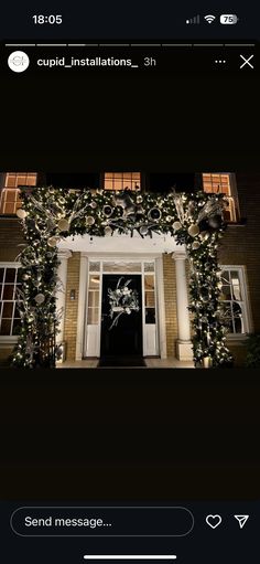 the front door of a house decorated with christmas lights and greenery for an outdoor party