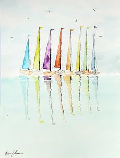 a group of sailboats floating on top of a body of water