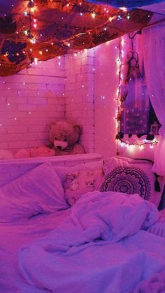 a bedroom with pink lights on the ceiling and a teddy bear sitting in the corner