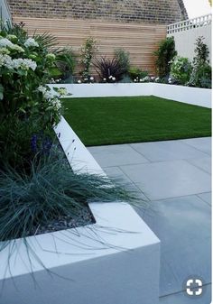 an outdoor garden with grass and flowers