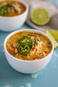 a white bowl filled with chicken tortilla soup and garnished with jalapenos