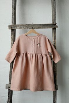 Anemone dress is made of 100% soft medium weight linen.  Details: - Choose size and embroidery in the drop down menu - Colour: Dusty rose - Composition: 100% Oeko-Tex certified linen - T shape - Gathered waist - Three coconut buttons - Medium weight linen - Linen care: machine wash gentle; tumble dry low, ironing optional - The price is for one dress, other pictured items are not included Dress Linen, Dress For Girls, Dress Girl, Flower Girl Dress, Style Expert, Linen Dresses, Anemone, Linen Dress, Girl Dress