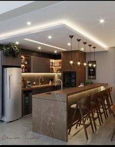 a modern kitchen with an island and bar stools