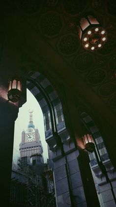 a clock tower is seen through an archway