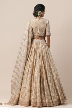 Ivory kalidar lehenga with cutwork detail, embroidered hip-yoke and hem border. Paired with zardosi grid blouse and striped dupatta embellished with crystal tassels.
Component: 3
Embroidered
Neckline: U Neck
Sleeve Length: Half
Fabric: Tulle, Kota Tulle, Tissue
Color: White
Bead tassels
Striped dupatta
Closure: Blouse: Back zip - Aza Fashions Beige Cutdana Anarkali Set For Reception, Reception Beige Anarkali Set With Cutdana, Reception Beige Cutdana Anarkali Set, Beige Anarkali Set With Zari Work For Reception, Beige Anarkali Set With Traditional Drape For Reception, Beige Chanderi Set For Reception, Beige Sets For Navratri Reception, Beige Sets For Reception During Navratri, Cream Anarkali Set With Pallu For Reception