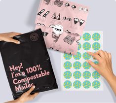 two hands are holding bags with stickers on them and one has a bag that says hey, i'm 100 % compostable mail