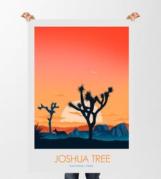 the joshua tree national park poster is displayed in front of a white wall with two hands holding